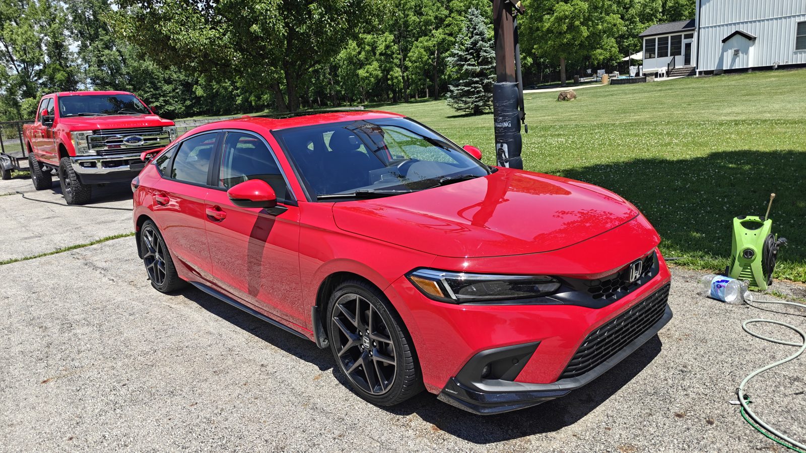 Red sedan paint polished to a deep gloss in a Newark, Ohio driveway