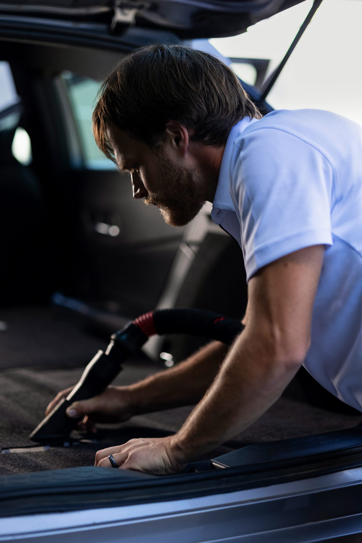 JMIDS detailer steam cleaning an SUV cargo area during a full inside and out detailing appointment in Newark, Ohio