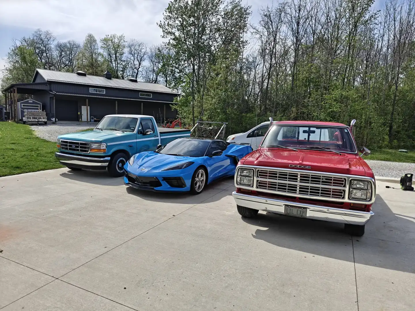 Blue Corvette, classic red Dodge pickup, and blue Ford truck detailed inside and out at a Newark, Ohio shop